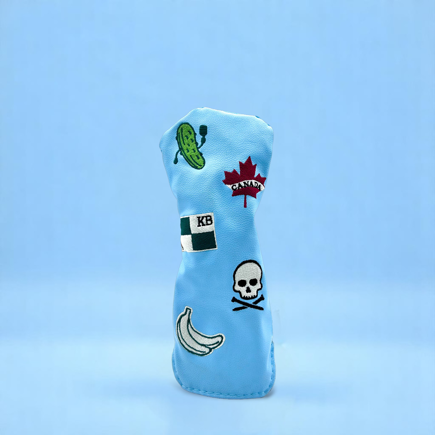 Blue golf club hybrid head cover with custom patches on blue backdrop