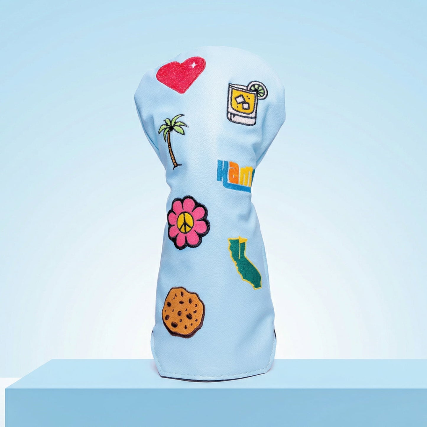 Custom light blue driver head cover with tropical patches including palm tree and hibiscus flower - personalized golf cover