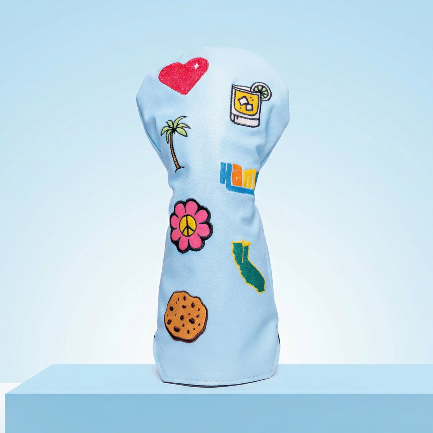 Custom light blue driver head cover with tropical patches including palm tree and hibiscus flower - personalized golf cover