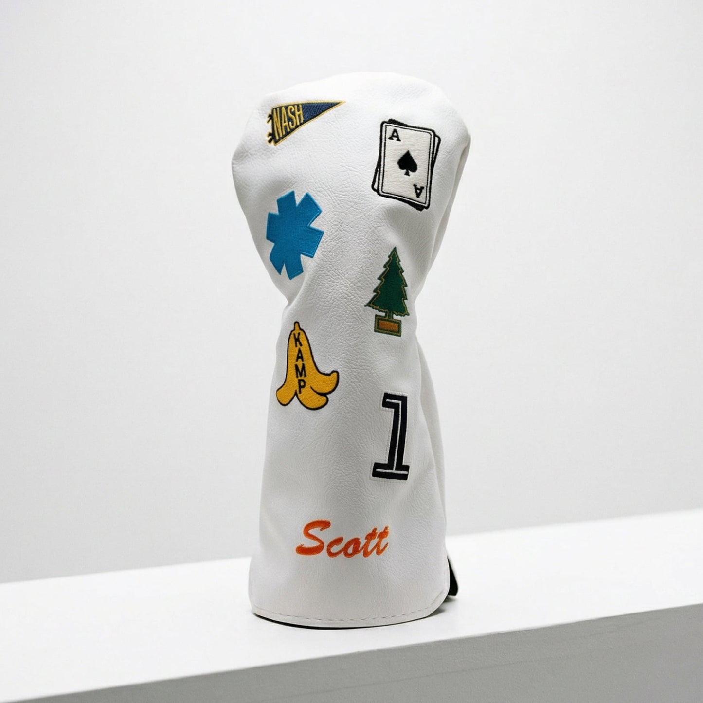 White personalized driver golf club cover showing embroidered patches and custom monogramming - side view