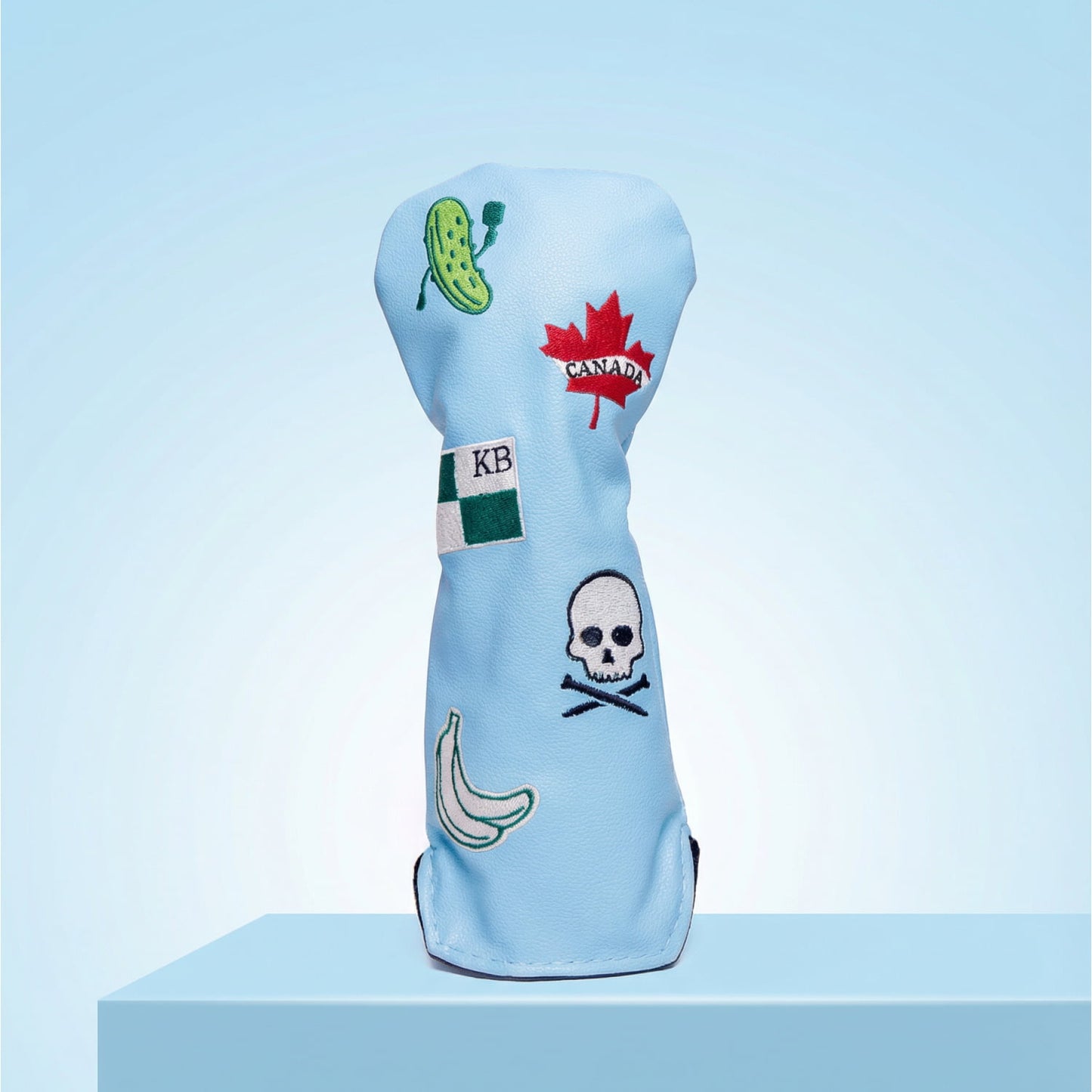 Custom light blue hybrid head cover with Canada maple leaf, KB flag, pickle, skull, and banana patches - personalized golf cover