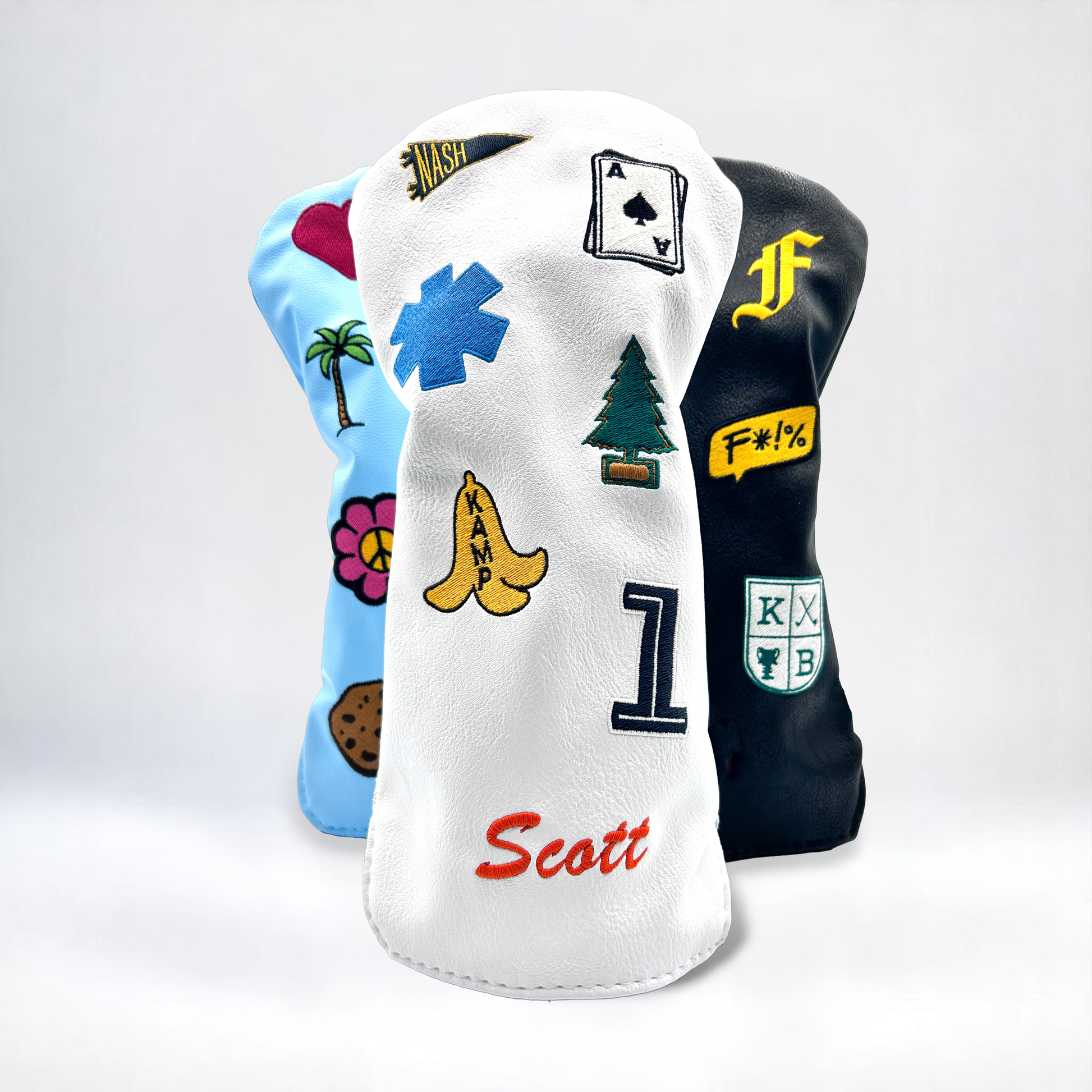Driver golf club head covers with custom patches on white backdrop