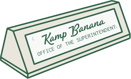 Desktop nameplate reading "Kamp Banana Office of the Superintendent"